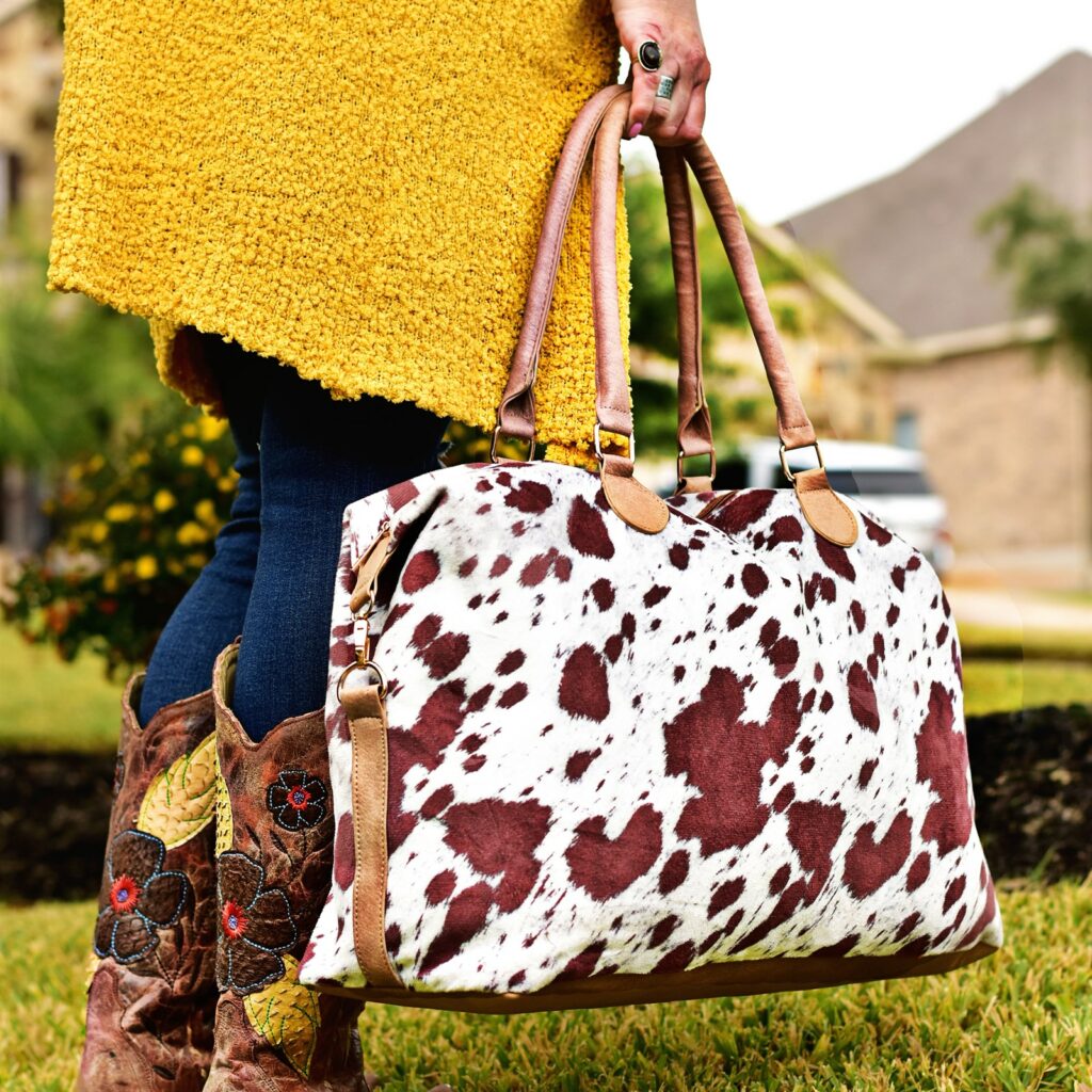 Travel In Style With Our Cow Print Weekender Bag